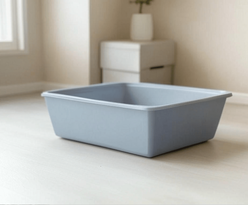 A clean, well-placed litter box in a quiet corner of a home. The image should show a peaceful, tidy area with no distractions, emphasizing the importance of location and cleanliness. 